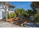 Manicured backyard with trees, a decorative fountain, and a stone pathway; serene and inviting at 1 Battery Park Rd, Edisto Island, SC 29438