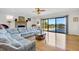 Bright living room features a large sofa, fireplace, and sliding glass doors to the deck at 1 Battery Park Rd, Edisto Island, SC 29438