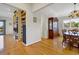 Open-concept living area with hardwood floors, built-in bookshelves, and a view into the dining room at 1 Battery Park Rd, Edisto Island, SC 29438