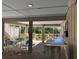 View of a covered outdoor patio with tables and chairs with views of the surrounding trees at 1 Battery Park Rd, Edisto Island, SC 29438