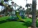 Community playground featuring a slide, climbing structures, and padded turf surface for safety at 1 Battery Park Rd, Edisto Island, SC 29438