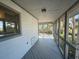 A screened in porch with a white hammock, wood flooring and view of the neighborhood at 1 Battery Park Rd, Edisto Island, SC 29438
