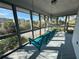 The screened-in porch features a vibrant blue swing and a relaxing hammock at 1 Battery Park Rd, Edisto Island, SC 29438