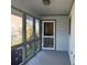 View of a screened in porch showing the screen door, wood flooring and exterior view at 1 Battery Park Rd, Edisto Island, SC 29438