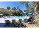 Lush swimming pool area with inviting sun loungers, umbrellas and beautiful palm trees at 1 Battery Park Rd, Edisto Island, SC 29438
