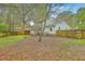 Fenced backyard with mature trees, providing privacy and shade; ideal for outdoor activities and entertaining at 107 Lewisfield Dr, North Charleston, SC 29418
