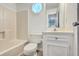 Cozy bathroom featuring a tub/shower combination, toilet, vanity, and a unique octagon window at 107 Lewisfield Dr, North Charleston, SC 29418