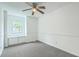 A bedroom with carpet, built-in storage under window, trim work and a ceiling fan at 107 Lewisfield Dr, North Charleston, SC 29418