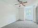 Bright bedroom featuring neutral carpet, a ceiling fan, and a window providing natural light at 107 Lewisfield Dr, North Charleston, SC 29418