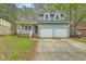 Charming two-story home with blue siding, double garage, and inviting front porch at 107 Lewisfield Dr, North Charleston, SC 29418