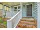 Inviting front porch with black front door, white railing, and brick steps at 107 Lewisfield Dr, North Charleston, SC 29418