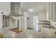 Kitchen with stainless steel range hood, granite counters, white cabinetry, double sink and a pass through bar at 107 Lewisfield Dr, North Charleston, SC 29418