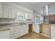 Kitchen area featuring white cabinetry, a stainless steel range hood and a double bowl sink with a window at 107 Lewisfield Dr, North Charleston, SC 29418