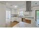 Bright kitchen with white cabinets, a range hood, granite counters, a window and a view to the living room at 107 Lewisfield Dr, North Charleston, SC 29418