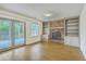A living room featuring a brick fireplace, built-in shelving and french doors to the outside deck at 107 Lewisfield Dr, North Charleston, SC 29418