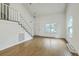 Bright living room with vaulted ceiling, hardwood floors, and staircase at 107 Lewisfield Dr, North Charleston, SC 29418