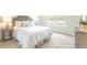 Comfortable bedroom with bedside table, soft carpet, white walls, and natural light from the window at 107 River Hill Rd, Goose Creek, SC 29445