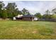 View of the backyard, highlighting the well-maintained lawn and home's exterior at 1085 Russellville Rd, Saint Stephen, SC 29479