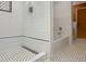 Bathroom featuring a shower and tub combo with white tile, patterned floor, and modern fixtures at 1085 Russellville Rd, Saint Stephen, SC 29479