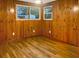 Bedroom featuring wood paneling, hardwood floors, and ample natural light from the windows at 1085 Russellville Rd, Saint Stephen, SC 29479