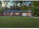 Charming brick home with a well-manicured lawn and mature trees creating a serene outdoor space at 1085 Russellville Rd, Saint Stephen, SC 29479