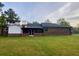 Exterior view of the home with a brick and siding combination and a screened-in porch at 1085 Russellville Rd, Saint Stephen, SC 29479