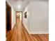 Bright hallway featuring gleaming hardwood floors and neutral wall paint at 1085 Russellville Rd, Saint Stephen, SC 29479