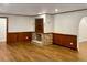 Cozy living room with wood paneled walls, a decorative fireplace, and hardwood floors at 1085 Russellville Rd, Saint Stephen, SC 29479