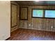 Room featuring wood paneled walls, wood flooring, and natural light from the windows at 1085 Russellville Rd, Saint Stephen, SC 29479