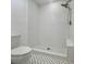 Modern white tiled shower with stylish fixtures and design, complemented by patterned floors at 1085 Russellville Rd, Saint Stephen, SC 29479