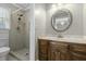 Bathroom featuring a wooden vanity, a decorative mirror, and a step-in tiled shower at 1109 Lee Shore Ln, Mount Pleasant, SC 29464