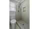 Bright bathroom featuring a tiled stand up shower and a white toilet next to a window at 1109 Lee Shore Ln, Mount Pleasant, SC 29464