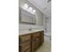 The bathroom features a wood vanity, marble countertop, decorative mirror, and shower-tub combo at 1109 Lee Shore Ln, Mount Pleasant, SC 29464