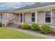Inviting entrance to a brick home, featuring colorful flowers and a well-kept lawn at 1109 Lee Shore Ln, Mount Pleasant, SC 29464