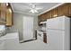 A kitchen features wooden cabinetry, white appliances, and a white door leading outside at 1109 Lee Shore Ln, Mount Pleasant, SC 29464