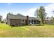 A spacious backyard featuring a brick house with a screened-in porch at 1144 Island View Dr, Mount Pleasant, SC 29464