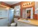 Traditional bathroom with patterned wallpaper, a shower with glass sliding door, vanity and mirror at 1144 Island View Dr, Mount Pleasant, SC 29464