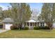 Charming brick home with a manicured lawn, flowering bushes, and inviting front porch at 1144 Island View Dr, Mount Pleasant, SC 29464