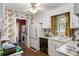 Traditional kitchen with a floral wallpaper design and white appliances, with washer and dryer room in the background at 1144 Island View Dr, Mount Pleasant, SC 29464