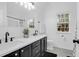 Modern bathroom featuring a double vanity with black hardware and ample natural light at 1174 Pittsford Cir, Charleston, SC 29412