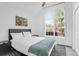 Bedroom featuring high ceilings, large arched window and black modern furniture at 1174 Pittsford Cir, Charleston, SC 29412