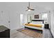 Bright bedroom with neutral walls, ceiling fan, decorative rug and black modern furniture at 1174 Pittsford Cir, Charleston, SC 29412