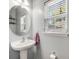 Powder room featuring a pedestal sink, decorative mirror, and a bright window at 119 Oakbluff Rd, Summerville, SC 29485