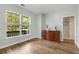 Well-lit room with a large window overlooking greenery and classic wood flooring at 119 Oakbluff Rd, Summerville, SC 29485
