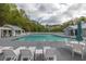 Spacious community pool with lounge chairs and shaded seating areas at 119 Oakbluff Rd, Summerville, SC 29485