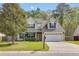 Charming two-story home featuring a manicured lawn and attached two car garage at 119 Oakbluff Rd, Summerville, SC 29485