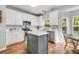 Modern kitchen boasts white cabinets, stainless appliances and a gray center island at 119 Oakbluff Rd, Summerville, SC 29485