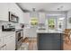 Modern kitchen with white cabinets, stainless steel appliances, and center island at 119 Oakbluff Rd, Summerville, SC 29485