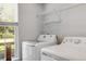 Laundry room features a washer, dryer, and natural light from the window at 119 Oakbluff Rd, Summerville, SC 29485
