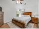 Spacious main bedroom features a wooden bed set, rug, and bright windows at 119 Oakbluff Rd, Summerville, SC 29485